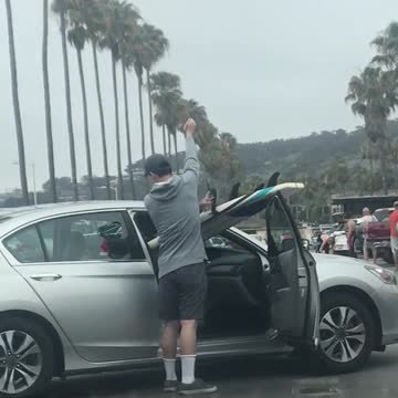 Guy in silver car surf board passenger seat