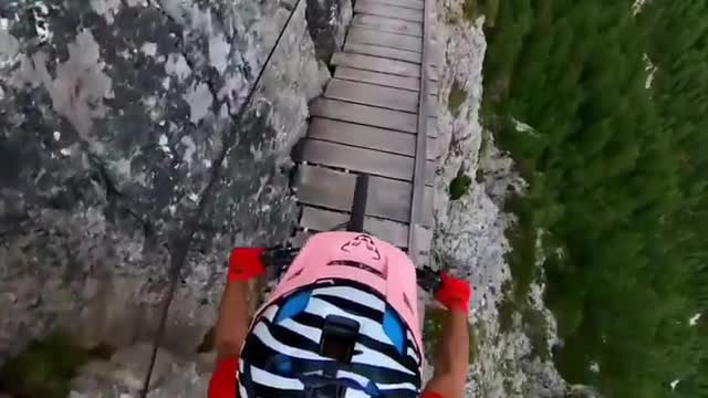 TOP VIEW OF THE CYCLIST HELMET DRIVING DOWN THE MOUNTAIN