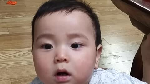Teasing a baby with ice cream.