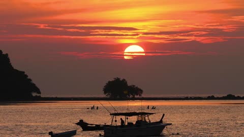 Boats in the ocean at dusk