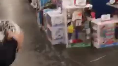 Black shorts dunks wreath in plastic basketball hoop falls over