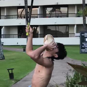Man Lighting the Tiki Torches at Sunset
