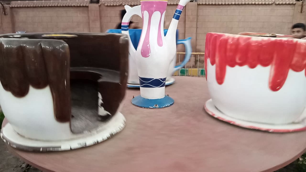 My Daughter Is Enjoying Cup Swing With Her Cousin And Mom