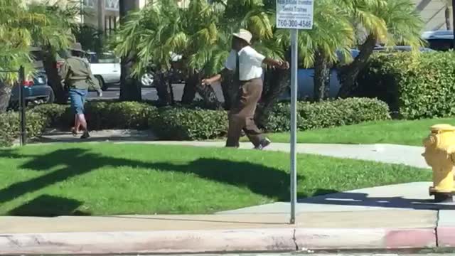 Older Gentleman Dancing his way across crosswalk in broad daylight