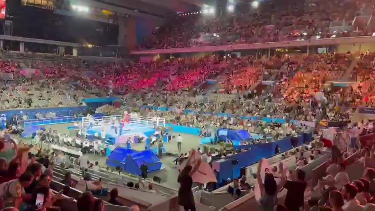 Woman holds up giant ‘XX’ banner whilst staging a protest at the Paris Olympics