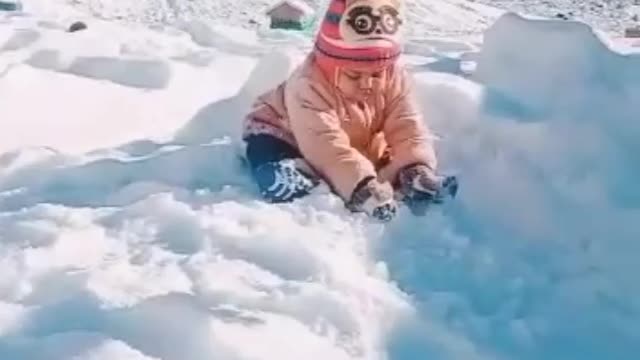 Cute baby play with snow