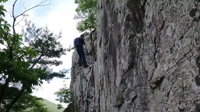 A hiker who climbs a bumpy trail