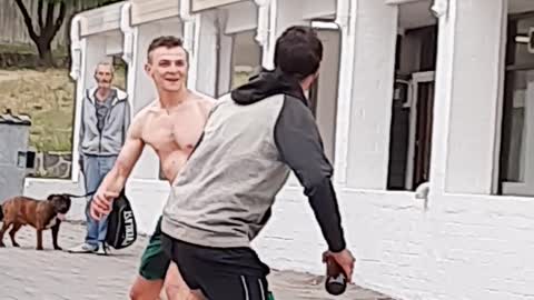 Shirtless Man Scuffles with Dude Carrying Groceries