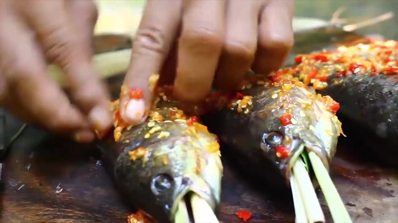 Thai village man cooking roast chicken.