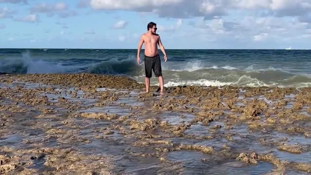 Big Wave Plows Over Man on Beach