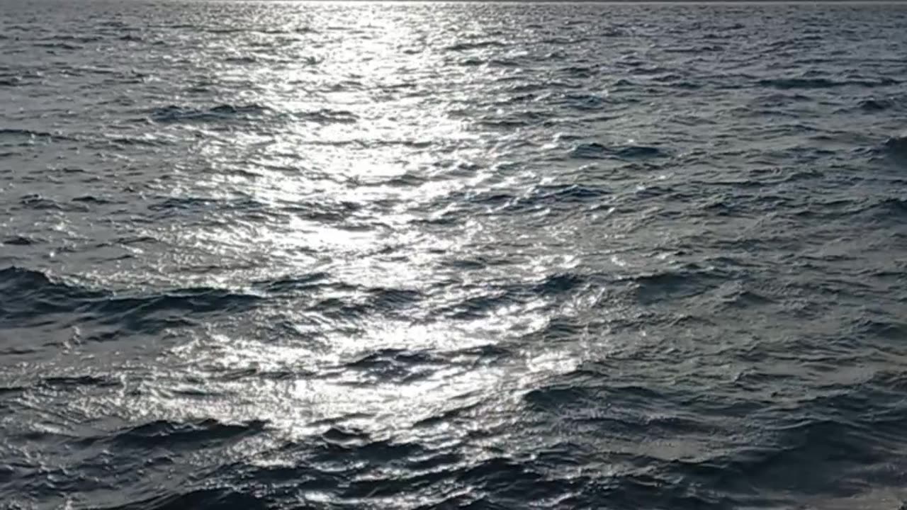 A beautiful natural view of the sea with calm waves and the wonderful sun