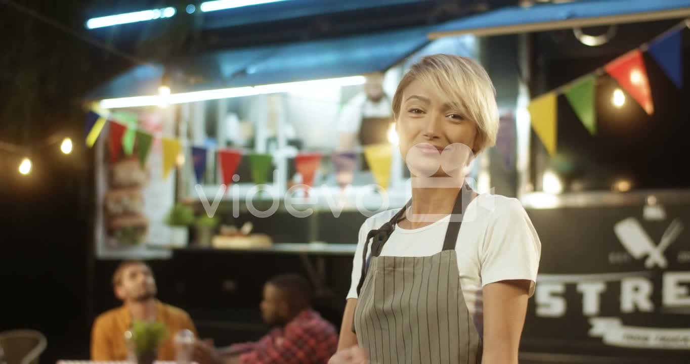 Happy Pretty Cheerful Young Woman In Apron With Blond Short Hair Turning And Smiling