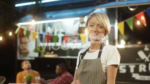 Happy Pretty Cheerful Young Woman In Apron With Blond Short Hair Turning And Smiling