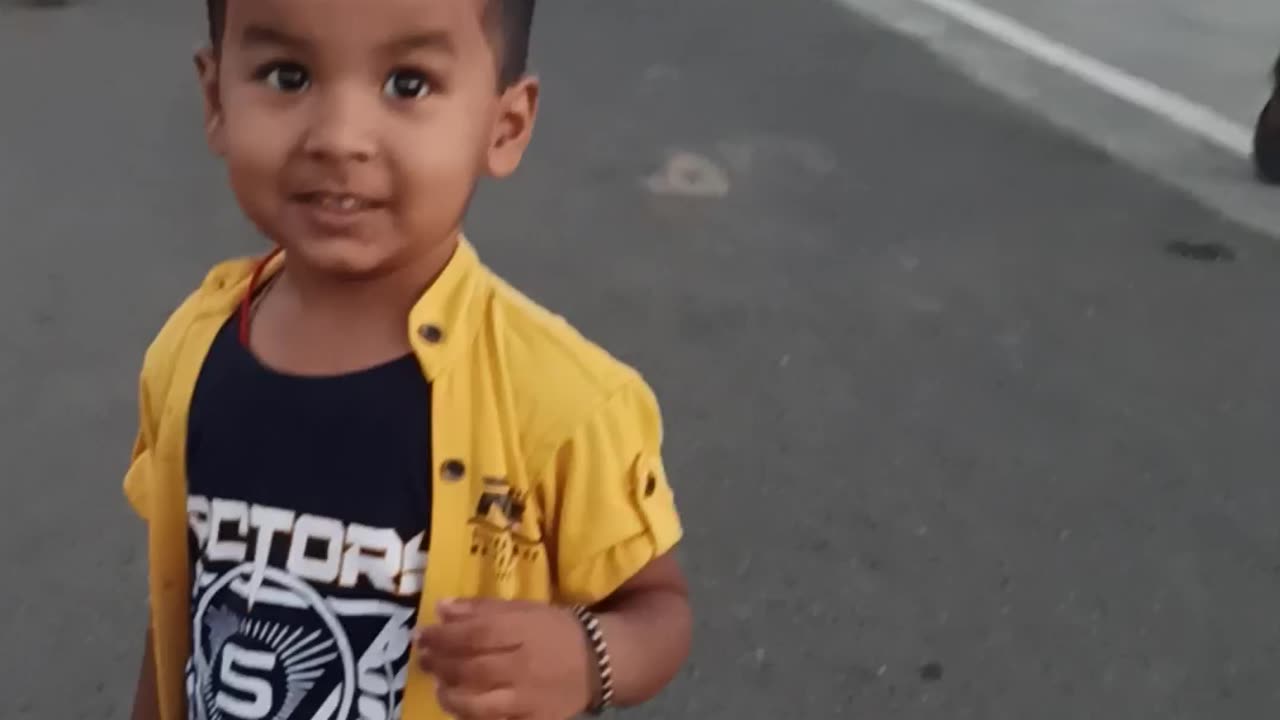 a small boy walking alone on running city rode with full confidence................