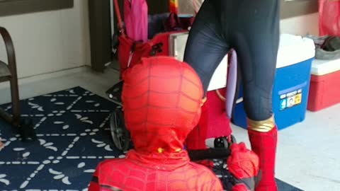 Houston superhero party character iron spider catches dinosaur in web game at a Pearland birthday