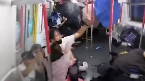 Police in Hong Kong beat up protesters on train