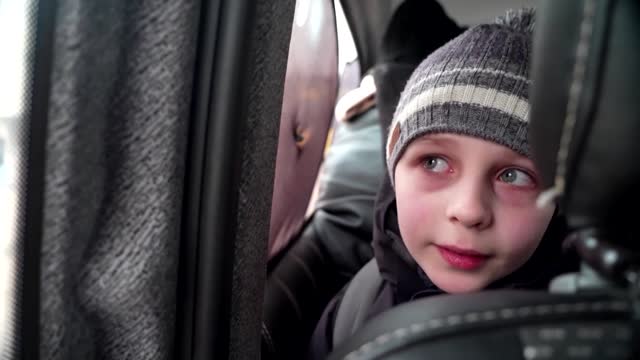 'We left our Dad in Kyiv' -little boy chokes back tears