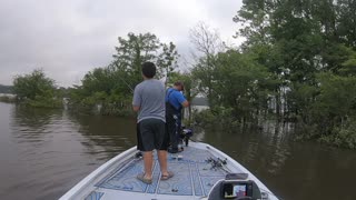 Father Hooks Son's Hat while Fishing