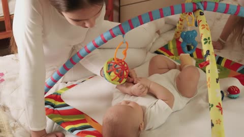 Little sister plays with her baby brother