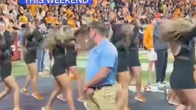 DANCING 'SECURITYGUARD' STEALS SHOWAT FOOTBALL GAME