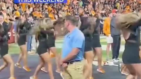 DANCING 'SECURITYGUARD' STEALS SHOWAT FOOTBALL GAME