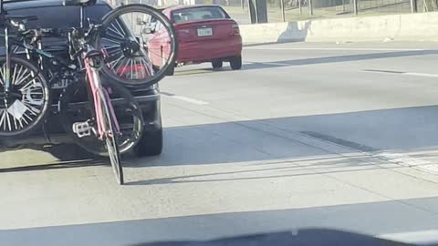 Bicycle Rides Behind Car on Highway