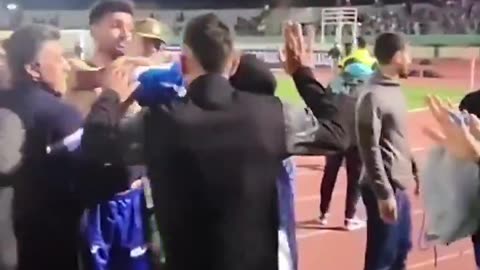 Goalkeeper embracing a female fan, whose hijab had fallen from her head