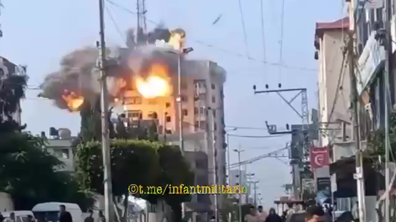 A guided aerial bomb strikes a residential apartment building in Gaza.