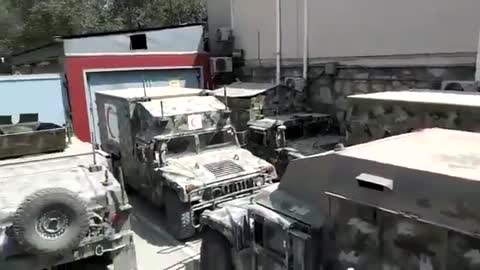 Taliban commander Abdul Hamid Hamasi inspects US-made armored vehicles in Kabul.