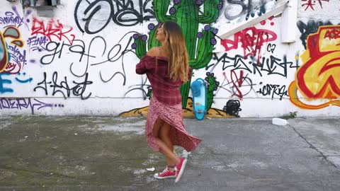 Trendy woman dancing in the street