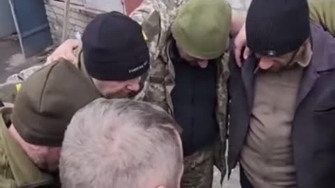 Ukrainian soldiers praying before going out to fight in Bakhmut.