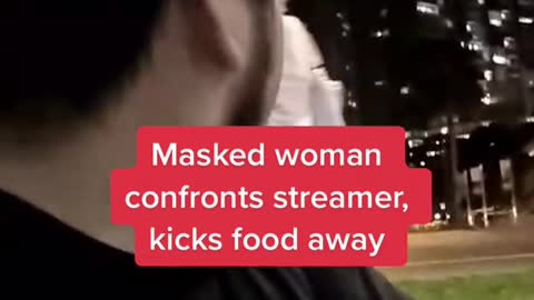 Masked woman confronts streamer, kicks food away