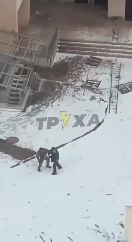 An old man is fighting an armed invader with his bare hands.