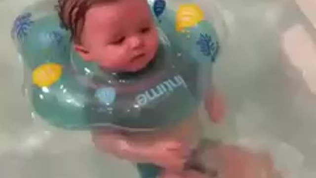 Cute Baby swimming and playing in water