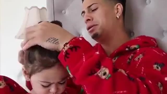 Dad combs his daughter's hair