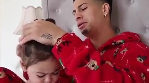 Dad combs his daughter's hair