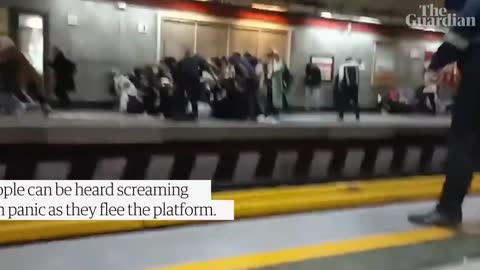 People run for cover as Iranian police open fire during protest at Tehran metro station