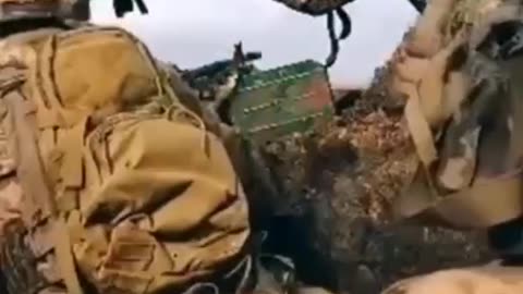 Ukrainian solder hit while covering his machine gun