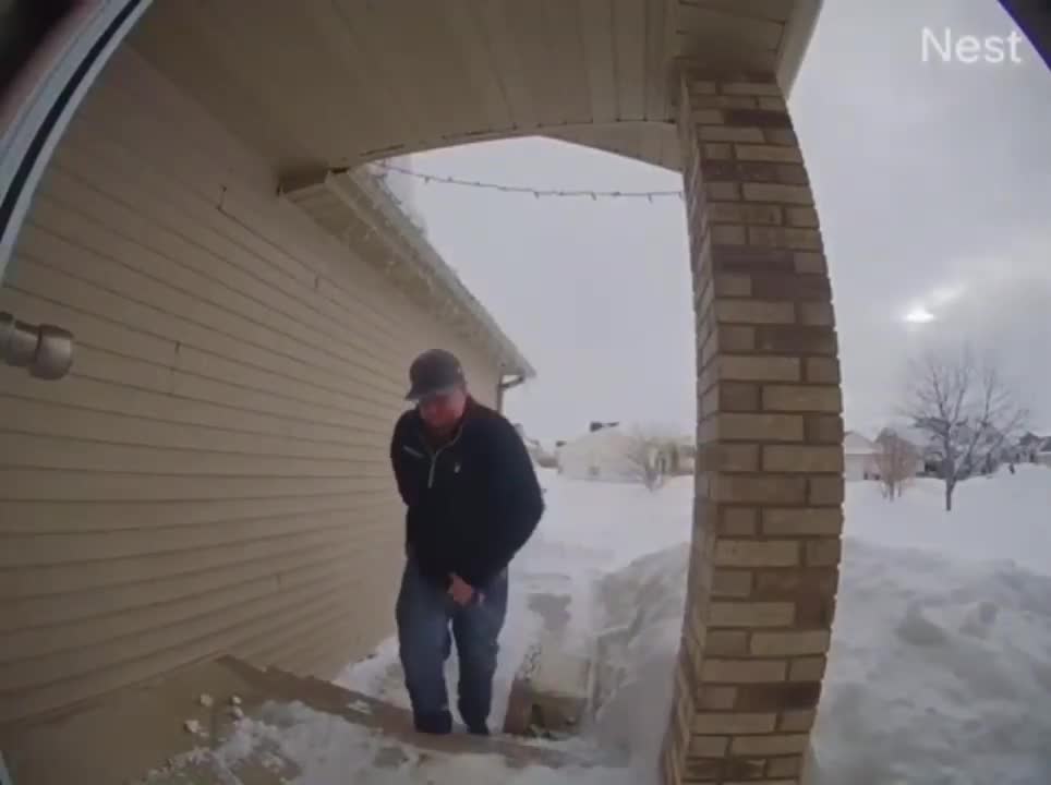 Guy Slips While Holding A Cooler And Going Down Snowy Stairs