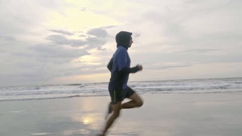 A Man Running On The Beach Shore