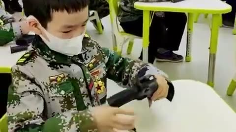 Chinese kids learn to load guns