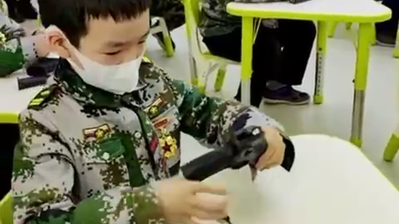 Chinese kids learn to load guns