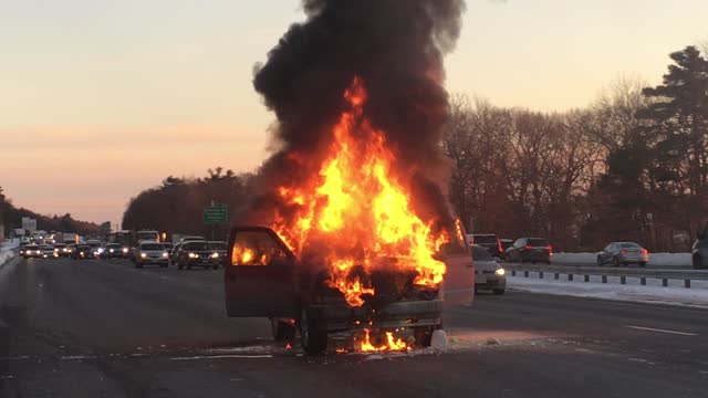 Truck destroyed by fire in the middle of the highway. A total loss.