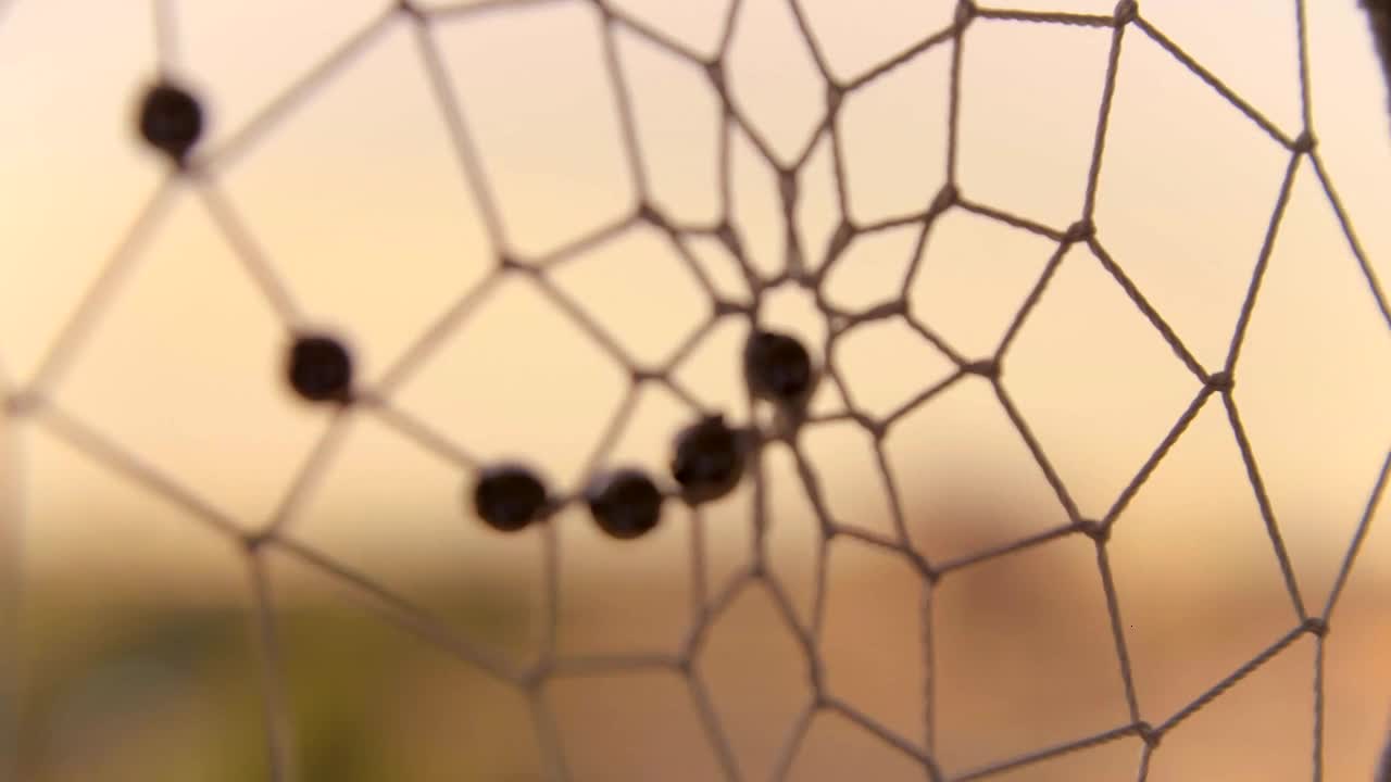 Extreme Close Up Shot of Dreamcatcher Web Spinning In the Wind