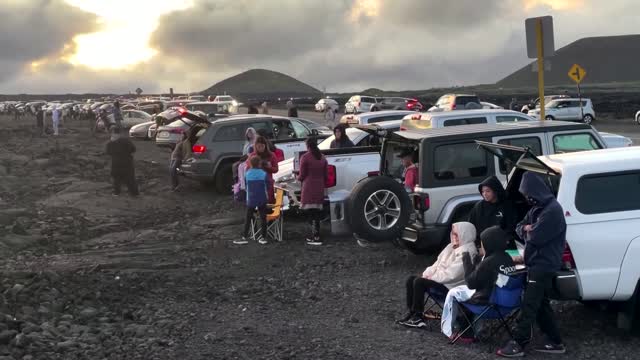 Spectators look on as Hawaii's Mauna Loa erupts