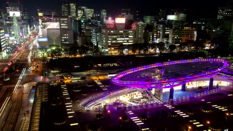 Cars and people in a city at night from the heights