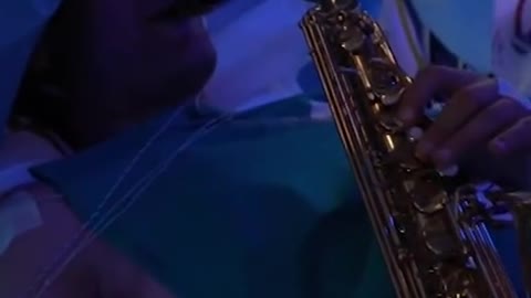 A musician plays his saxophone as he undergoes a very complex