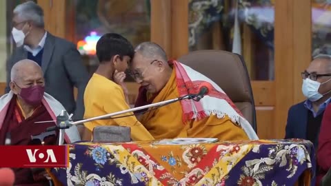 The Dalai Lama has apologised after kissing a small boy