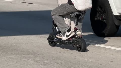 Sharing A Scooter On The Highway