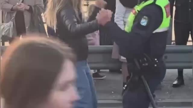 Police Officer invites woman to dance during